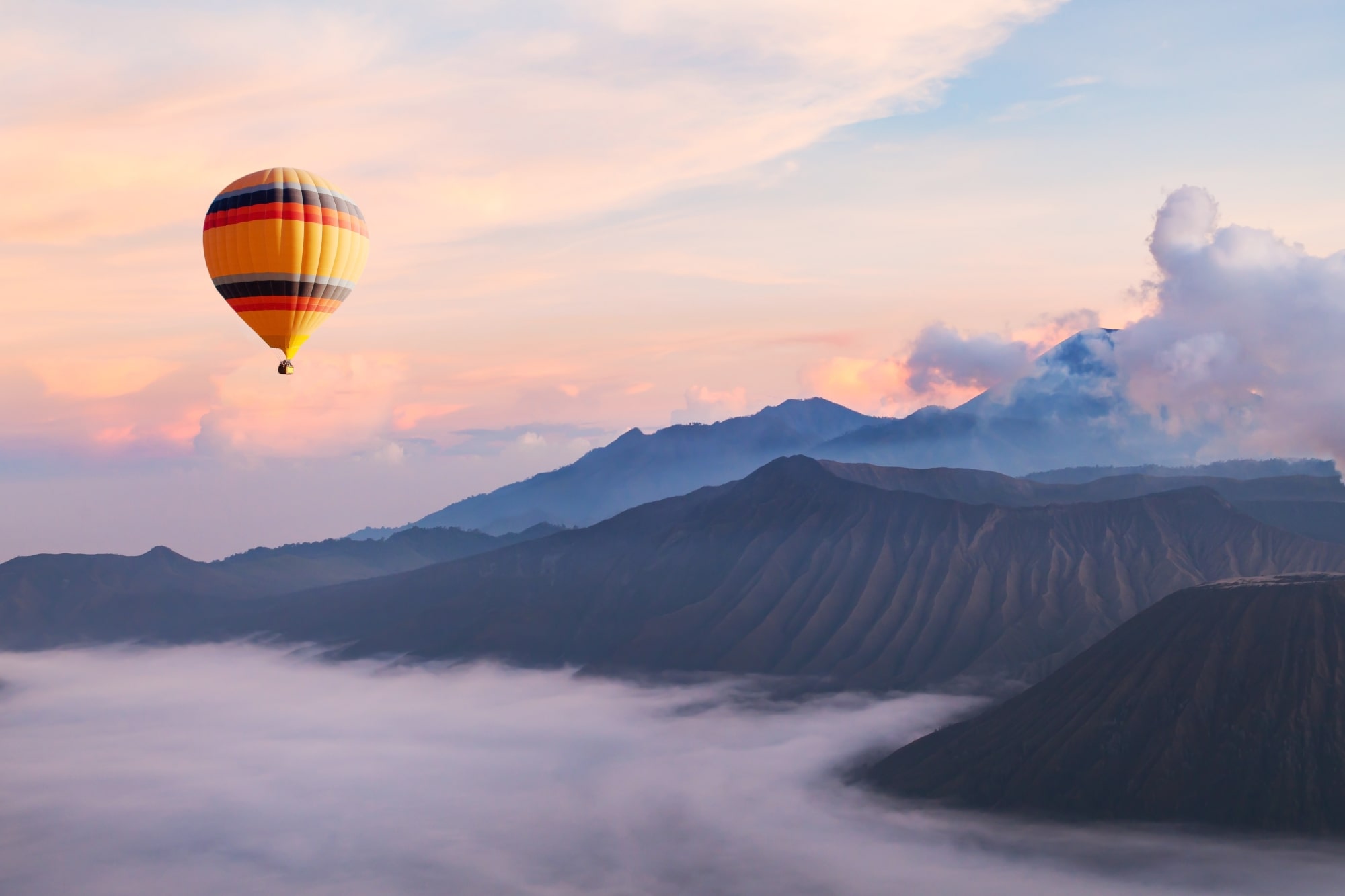 Hot air balloon floating over the clouds